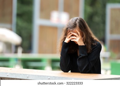 Young Woman Holding Her Head In Shame.