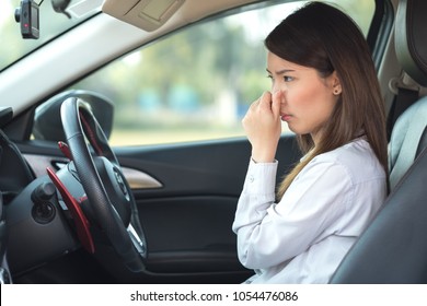 Young Woman Holding Her Nose Because Of Bad Smell In Car