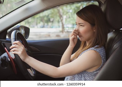 Young Woman Holding Her Nose Because Of Bad Smell In Car