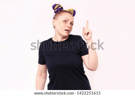 Young woman holding index finger up with great new idea. The woman has dreadlocks on her head, freckles on her face. On white background in studio. People lifestyle concept. Mock up copy space.