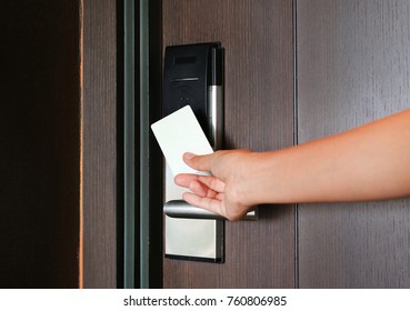 Young Woman Holding A Key Card To Unlock Door.