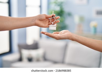 Young Woman Holding Key Of New House At Home