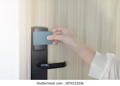 Young Woman Holding A Keycard Openning Hotel Door