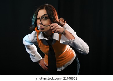 Young Woman Holding Magnifying Glass Like Detective. Investigation Concept On Black