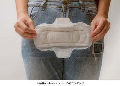 Young Woman Holding Menstrual Pad ,Women Period Product. Closeup Asian Female Holding Sanitary Napkin, In Hand. Woman Holding Clean Period Pad. Feminine Intimate Hygiene. High Resolution