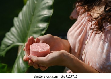 Young woman holding natural eco friendly solid shampoo bar, conditioner or soap. Zero waste and sustainable plastic free lifestyle concept - Shutterstock ID 1869129718
