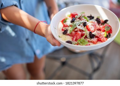 Young Woman Holding Parmesan Cheese, Tomato And Fresh Mint  Salad 