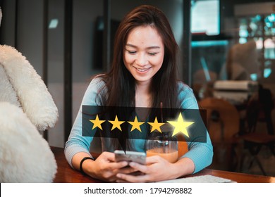 Young woman holding phone with five star services rating satisfaction.