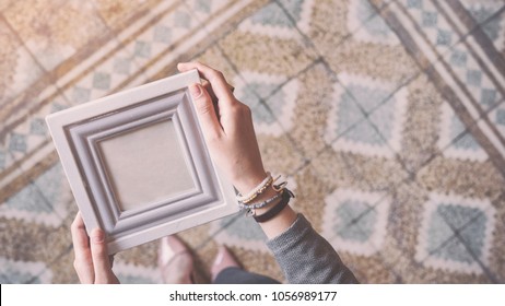 Young Woman Holding Photo Frame