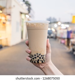 A Young Woman Is Holding A Plastic Cup Of Brown Sugar Bubble Milk Tea At A Night Market In Taiwan, Taiwan Delicacy, Close Up.