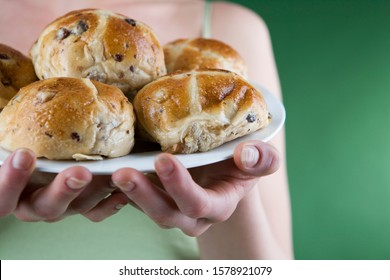 A Young Woman Holding A Plate Of Hot Cross Buns, Close-up