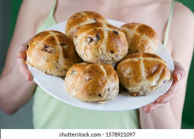 A Young Woman Holding A Plate Of Hot Cross Buns, Close-up