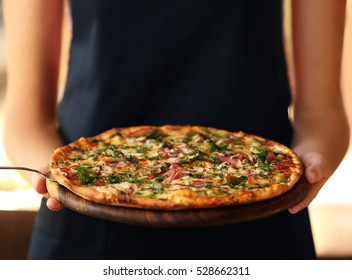 Young woman holding plate with tasty pizza, close up view - Powered by Shutterstock