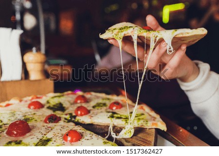 Young woman holding plate with tasty pizza, close up view.