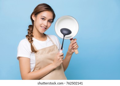 Young Woman Holding A Pot And A Ladle.