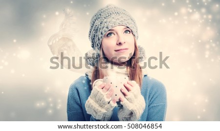 Young woman holding a red coffee mug
