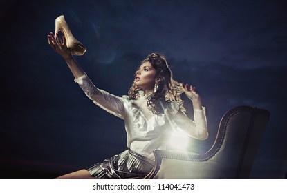 Young Woman Holding A Shoe