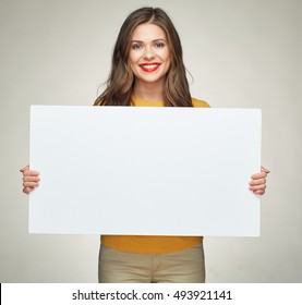 young woman holding  sign business board. isolated portrait of casual dressed woman.