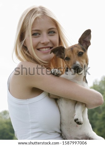 Similar – Pretty blond woman with her two dogs