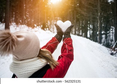 Young Woman Holding Snow Heart In Hands.Valentine's Day Concept