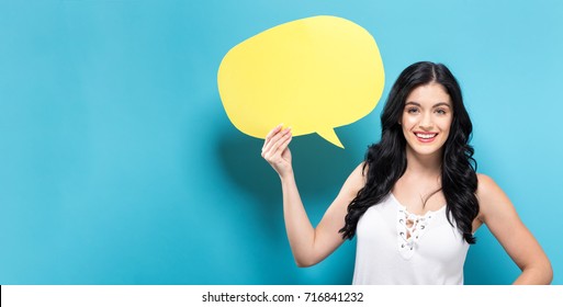 Young Woman Holding A Speech Bubble On A Solid Background