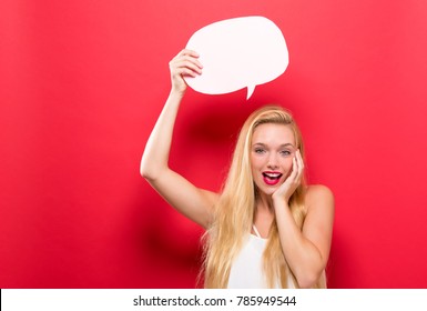 Young Woman Holding A Speech Bubble On A Solid Background