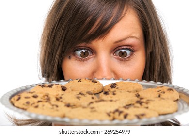 Young Woman Holding Staring At A Tray With Homemade Chocolate Cookies