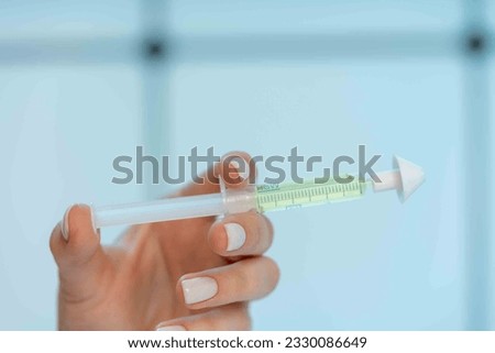 young woman holding a syringe with intranasal medical medicine in her hand