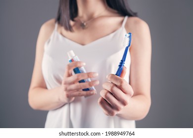 Young Woman Holding Toothpaste And Brush