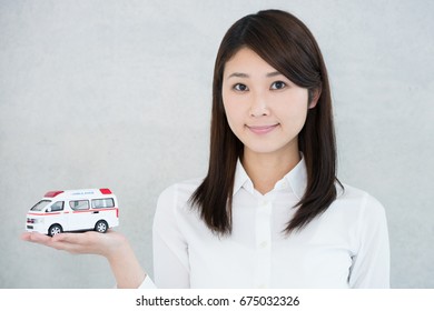 Young Woman Holding Toy Ambulance.