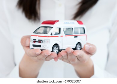 Young Woman Holding Toy Ambulance.