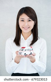 Young Woman Holding Toy Ambulance.