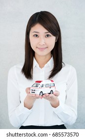 Young Woman Holding Toy Ambulance.