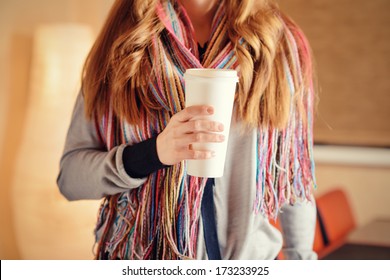 Young Woman Holding A Tumbler Of Coffee In Cafe.