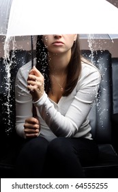 A Young Woman Holding An Umbrella. It's Raining Indoors. Depression - Concept.