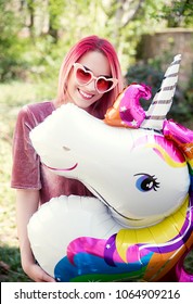 Young Woman Holding Unicorn Balloon