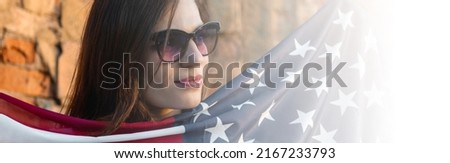 Young woman holding USA flag outdoors at sunset. Patriotic holiday. Independence day. Banner design