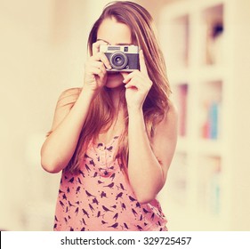 Young Woman Holding A Vintage Camera