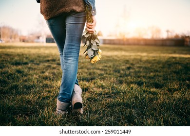 Young woman holding yellow rose - Shutterstock ID 259011449
