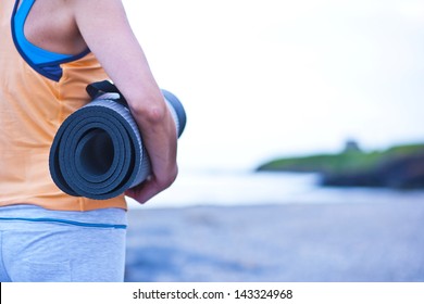  Young Woman Holding A Yoga Mat