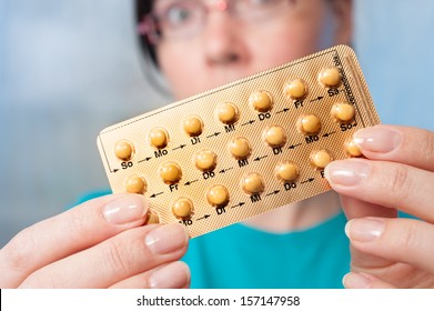 Young Woman Holds Birth Control Pills