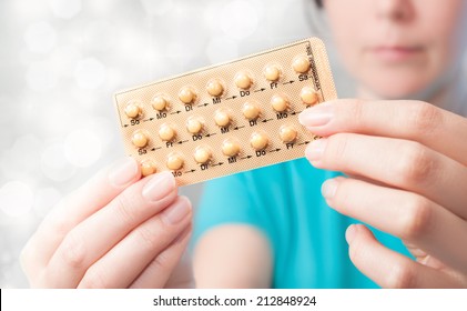 Young Woman Holds Birth Control Pills 