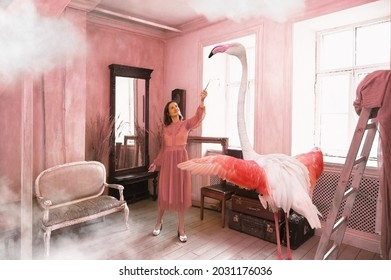 Young Woman Holds Out A Branch To A Pink Flamingo In A Sun Drenched Vintage Style Living Room
