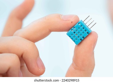 young woman holds a poison gas sensor in her hands to monitor air quality - Powered by Shutterstock