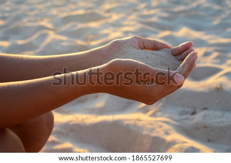 Similar – Hand im Sand Lifestyle