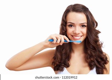 Young Woman At Home Brushing Teeth In The Morning