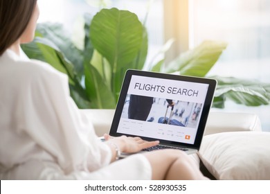 Young Woman At Home Checking Popular Destinations On Laptop, Trying To Get The Cheapest Flights, Planning Traveling For Business, Self-guided Tour, Last Minute Decision. View Over The Shoulder