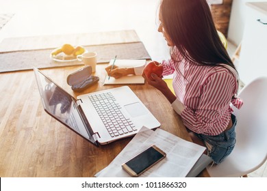 Young Woman At Home Planning Family Budget And Finances.