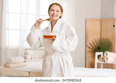 Young woman with honey in spa salon - Powered by Shutterstock