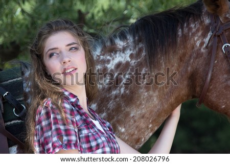 Young woman with horse, close up portrait
